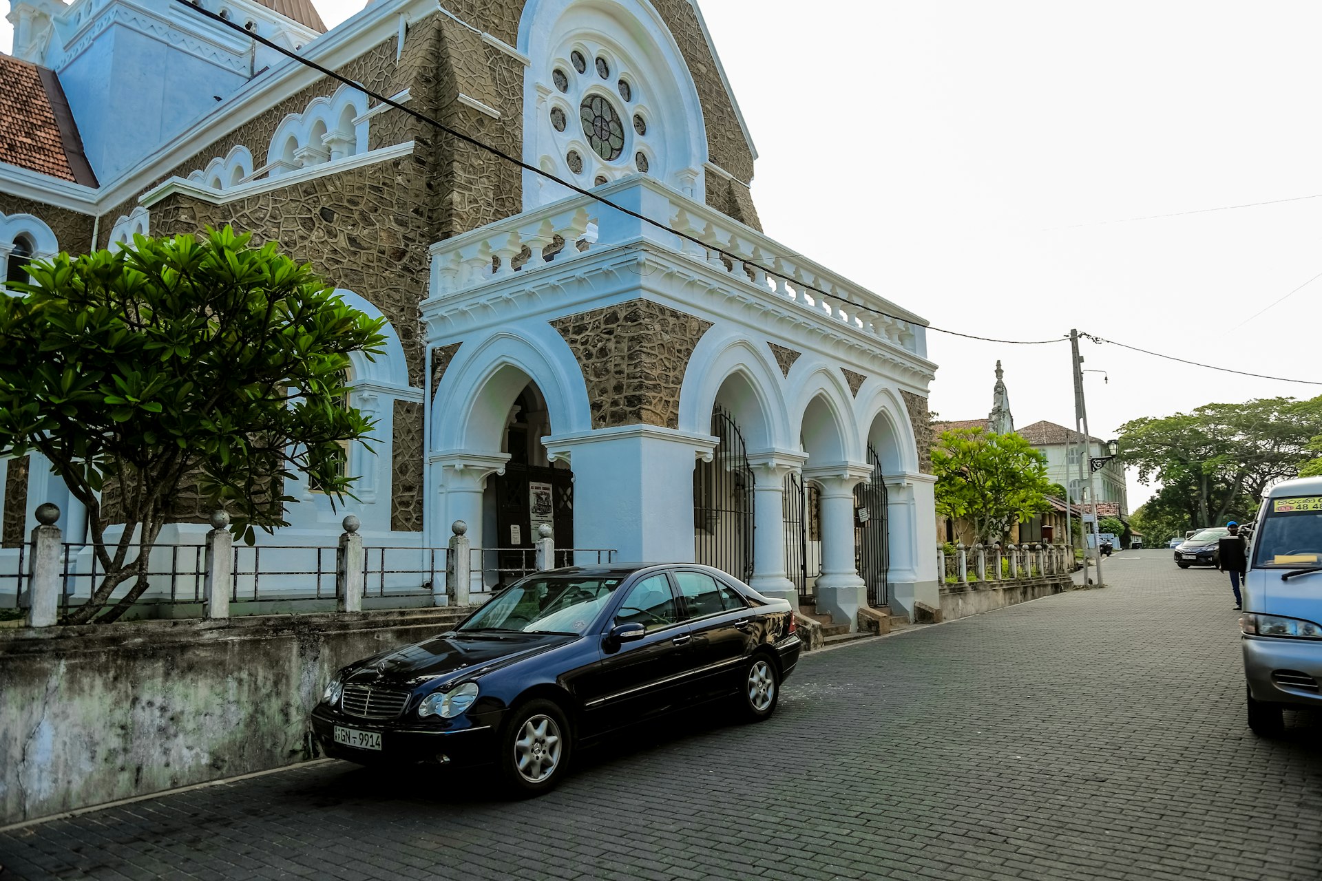 a black car parked in front of a church